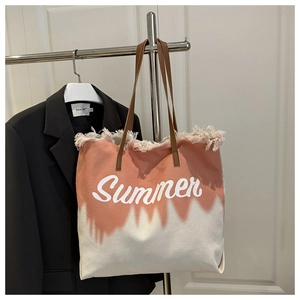 Close-up of gradient pink canvas tote bag with Summer embroidery and leather handles