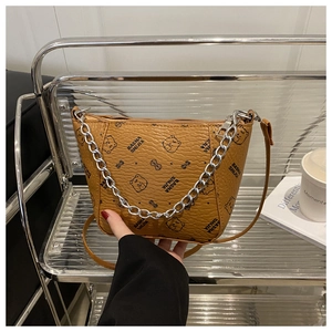 Detail of bear pattern textured leather bucket bag with chain strap and top handle