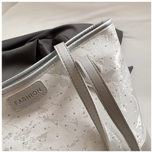 Detailed macro view of silver tote bag with marble texture and silver micro studs