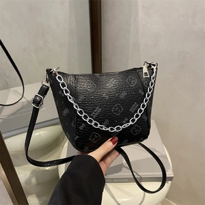 Luxury black leather bucket bag with bear print and stylish silver chain handle