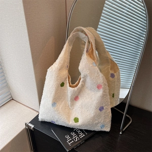 Chic white fuzzy tote bag with colorful polka dots shown in a creative mirror reflection