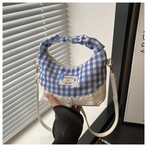 Detail of blue and white plaid handbag with lace trim and sweet baby handmade patch