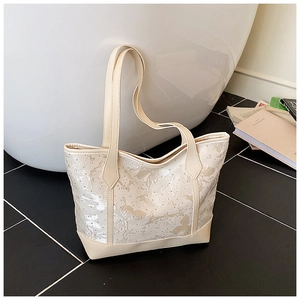 Detail of floral jacquard fabric on a cream tote bag with elegant butterfly pattern