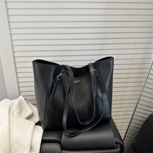 Classic large capacity black tote bag with shoulder straps and golden hardware buckles