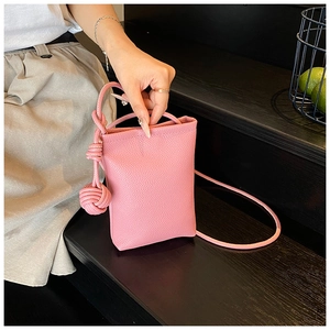 Pink litchi pattern mini crossbody bag featuring a unique knotted ball charm detail