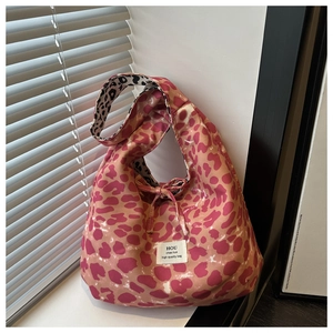 Detailed macro view of pink leopard canvas tote with drawstring and logo label