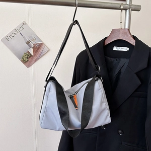 Light gray large capacity messenger bag with black shoulder strap and orange zipper detail