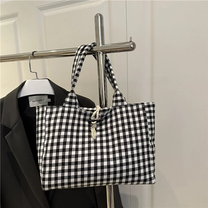 Minimalist black and white checkered canvas tote bag with a vintage horn buckle closure