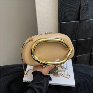 Elegant beige evening clutch with oval gold metal handle and fine chain shoulder strap
