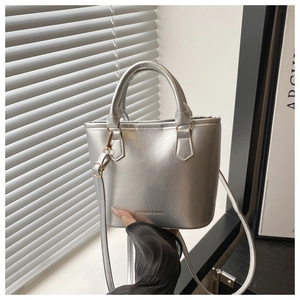 Detail of silver metallic mini tote with dual handles and Fashion & Bags engraving