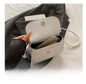 Detailed internal view showing capacity for a smartphone and wallet in a quilted bag