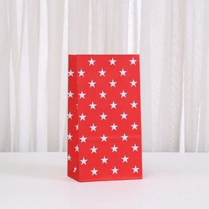 Red paper gift bag with white star pattern and zigzag edge for candy and party favors