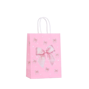 Pink paper gift bag with watercolor bow prints and white rope handles for birthday parties