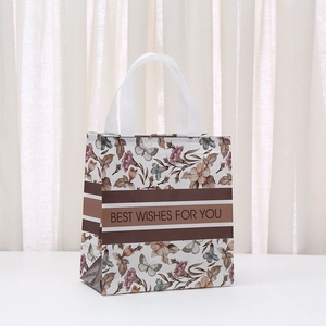 Floral laminated non-woven gift bag with butterfly patterns and ribbon handles