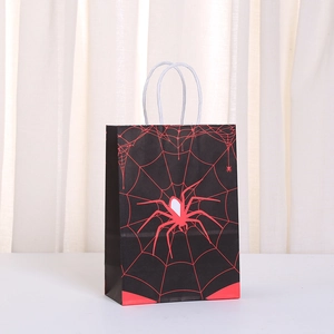 Close-up of Halloween paper gift bag with red spider and web pattern and rope handles