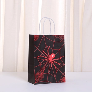 Detail of Halloween paper gift bag with red spider web design and twisted white handles