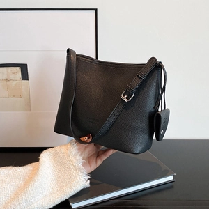 Classic black textured leather Hobo bucket bag with adjustable strap and small charm pendant