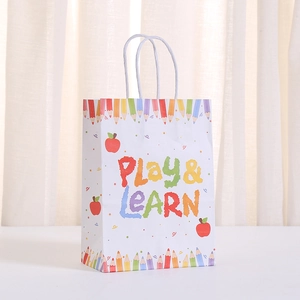 White Play & Learn gift bag with colorful pencil borders and rainbow lettering for school