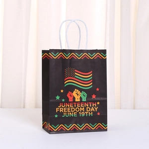 Juneteenth Freedom Day black paper gift bag with red yellow green festive design