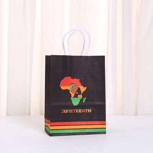 Juneteenth gift bag with African map silhouette and twisted handles on a neutral background