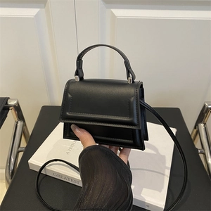 Chic black mini square crossbody bag with top handle and sleek leather finish
