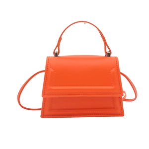 Minimalist orange mini trapezoid handbag with crossbody strap and geometric embossing