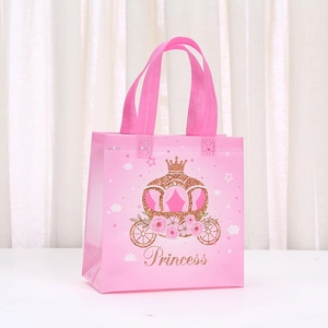 Detailed view of pink princess gift bag featuring a golden pumpkin carriage and crown
