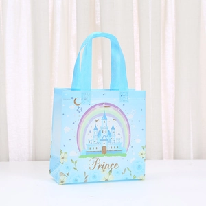 Close-up of a blue fairytale gift bag with a castle design and gold Prince text