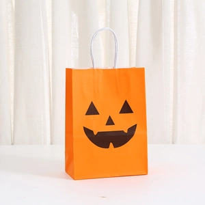 Orange Halloween kraft paper gift bag featuring a black pumpkin face and white rope handles