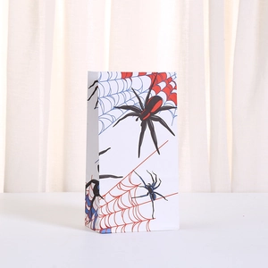 Halloween paper gift bag with spider and web print on white background standing upright
