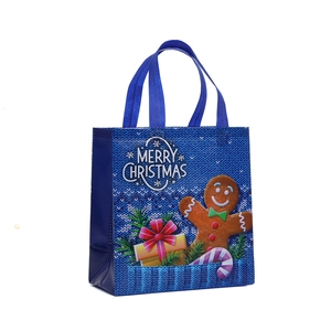Navy blue non-woven Christmas gift bag with gingerbread man print and merry christmas text