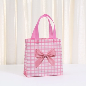 Pink checkered non-woven gift bag featuring a silky bow and durable double handles