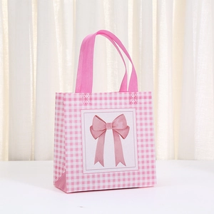 Pink and white checkered non-woven gift bag with a sweet bow print and sturdy handles