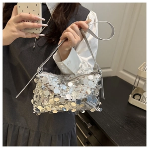 Detail of silver sequined shoulder bag with adjustable strap and zipper closure