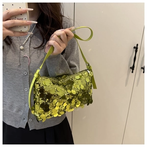 Macro detail of vibrant neon green sequins on a stylish shoulder bag with leather strap