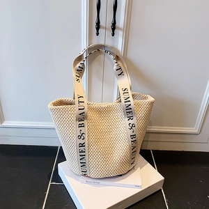 Off-white straw woven tote bag with Summer & Beauty logo straps for beach vacations