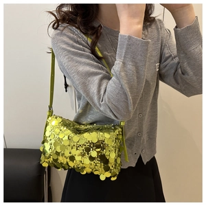 Detail of neon green sequins on a small evening shoulder bag with reflective texture