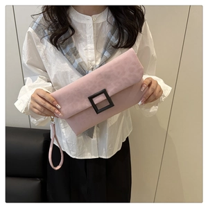 Detailed view of pink leopard print clutch bag with black square buckle and wrist strap