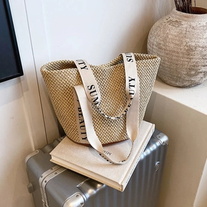 Handwoven straw tote bag with wide 'SUMMER BEAUTY' straps for beach travel and vacations