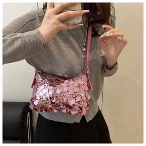 Close-up of pink round sequins on a trendy shoulder bag with metallic shine details