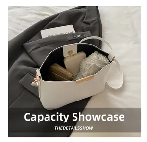 White bucket bag capacity display showing long wallet, power bank, and folding umbrella inside