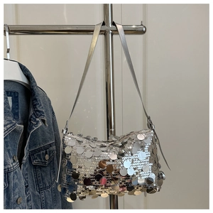 Detailed close-up of sparkling silver sequin handbag with reflective metallic finish