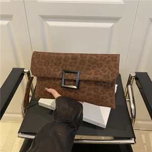 Brown leopard print suede shoulder bag with black square buckle and wristlet strap