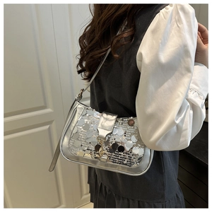 Detail view of silver sequin shoulder bag featuring a metallic lock and sleek strap