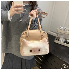 Detail of the cute milk tea brown cat-themed crossbody bag with plush cat face pocket