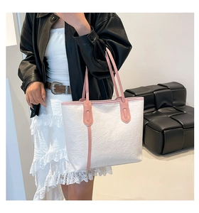 Gros plan détaillé d'un sac cabas blanc et rose avec motifs de dessins animés gaufrés sur mannequin