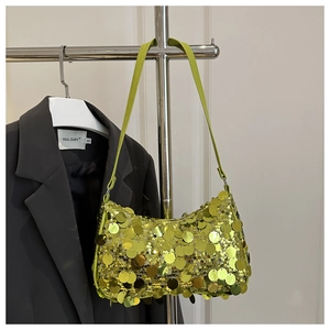 Detailed close-up of a neon yellow sequin baguette bag hanging on a metallic hanger