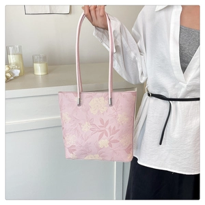 Detailed view of pink floral tote bag with thin handles for daily office commute