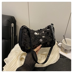 Detail of black sequined shoulder bag with silver metallic chain and leather strap
