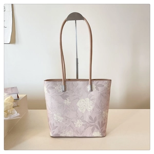 Detail of floral tote bag showing high-quality canvas texture and sturdy metal hardware